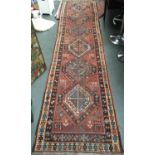 A West Persian runner rug, six lozenges within a double border, 390x95cm