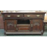 A substantial mahogany sideboard, two drawers over central cupboards, with carved detail,