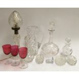 A mixed lot of cut glass items, to include table lamp, decanter, water jug, several small decanters,