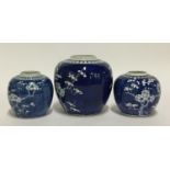 Three blue and white ginger jars, the largest 16cmH