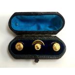 A boxed set of three Victorian 18ct shirt studs, 4.6g