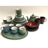 A Denby part dinner service comprising dinner plates, side plates, cups, saucers, teapot etc;