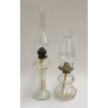 Two glass oil lamps, each with chimney, 40cmH and 50cmH