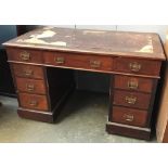A Victorian walnut kneehole desk with the traditional arrangement of nine drawers, on casters,