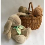 A wicker basket containing a Harrod's teddy bear and two others