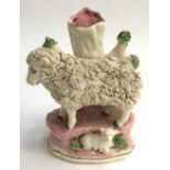 A Staffordshire style encrusted ewe with lamb spill vase, the rim heightened in gilt, 14cmH