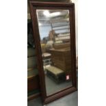 A large wall mirror with bevelled glass