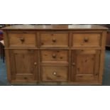 A substantial Sardinian sideboard, three drawers over two further drawers flanked by cupboards,