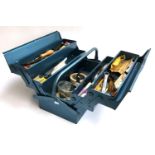 A metamorphic metal toolbox containing various tools, hammers, pliers, spanners etc