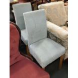 A pair of modern upholstered dining chairs