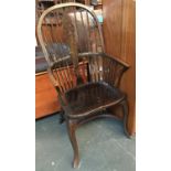 A late 19th/early 20th century wheelback windsor chair, with bentwood front arm supports, shaped