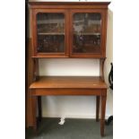 A glazed display cabinet over a mahogany side table on square tapered legs, 106x46x189cmH
