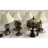 A set of four table lamps; together with a lamp with tiffany style shade and one other shade