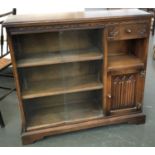 A 20th century oak bookcase, sliding glass doors with drawer and linen fold cupboard, 94cmW