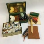 A large collection of artist's materials to include pastels, paintbrushes, pallet knives, a large