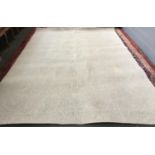 A large wool oatmeal rug, 340x260cm