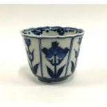 A Japanese blue and white porcelain tea cup, floral panelled design, marked to base, approx. 7cmH