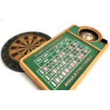 A roulette table together with a Taurus Wabo dartboard