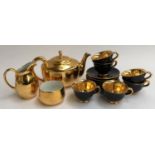 A Royal Worcester three piece gilt tea set; together with a gilt and black Italian cups and saucer
