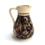 An antique McIntyre signed mid-19th century slipware glazed marbled effect jug, 18cmH