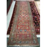 A large West Persian runner rug, with triple border