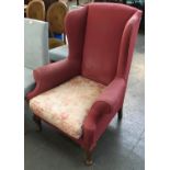 A wingback armchair on cabriole legs