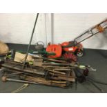 A quantity of vintage tools to include chimney sweeps, rake, strimmer, spade, watering can,