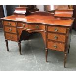 An early 20th century kneehole desk, with two piers with hinged cavetto lids above traditional