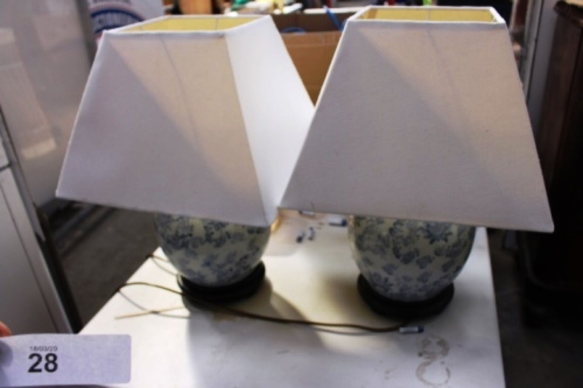 A pair of Chinese blue and white pottery bulbous shape lamp bases with off white rectangular lamp