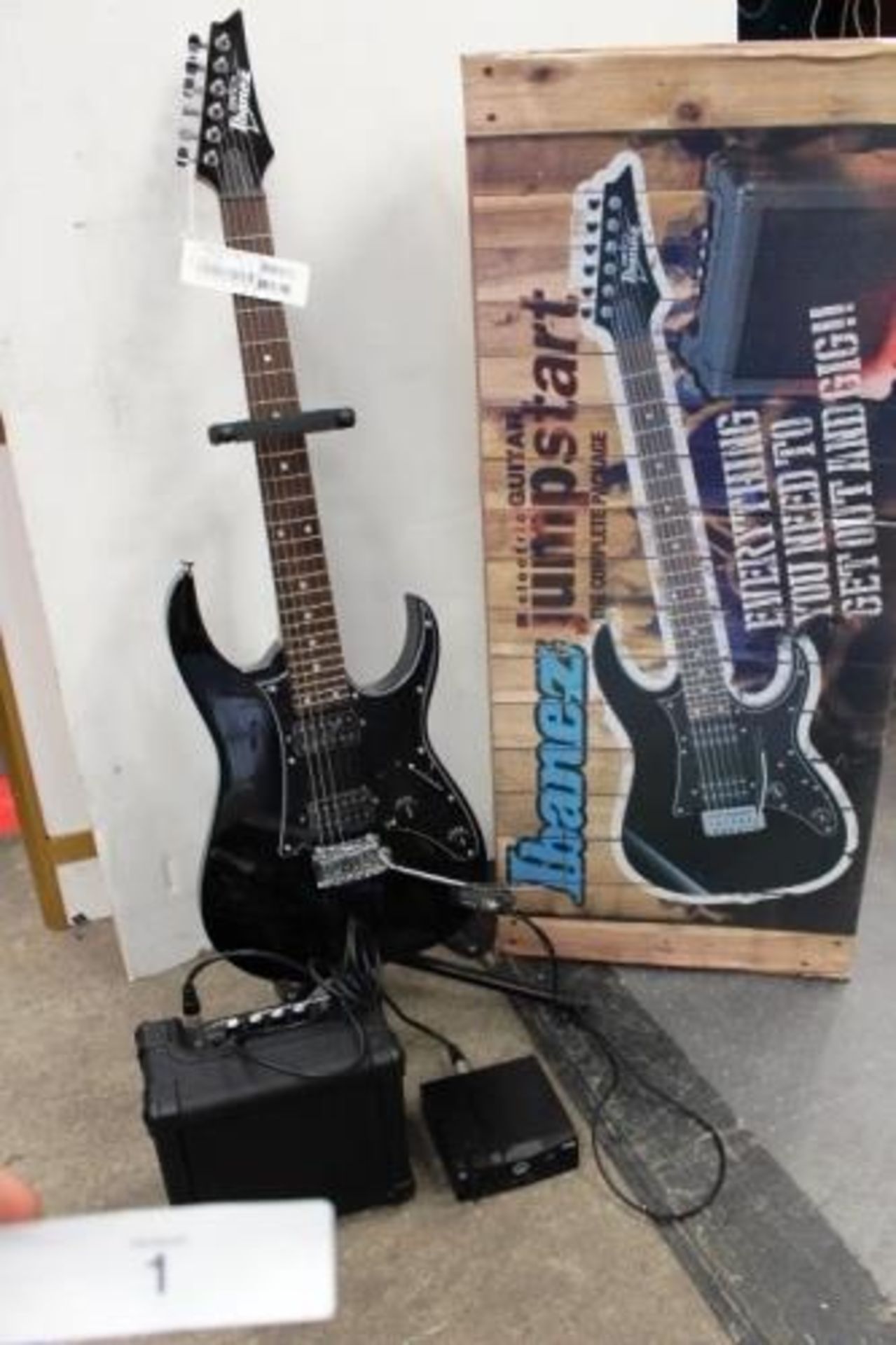 An Ibanez electric guitar, model IJRG200E-BK, new, together with an IBZ2G guitar amp and an AKG