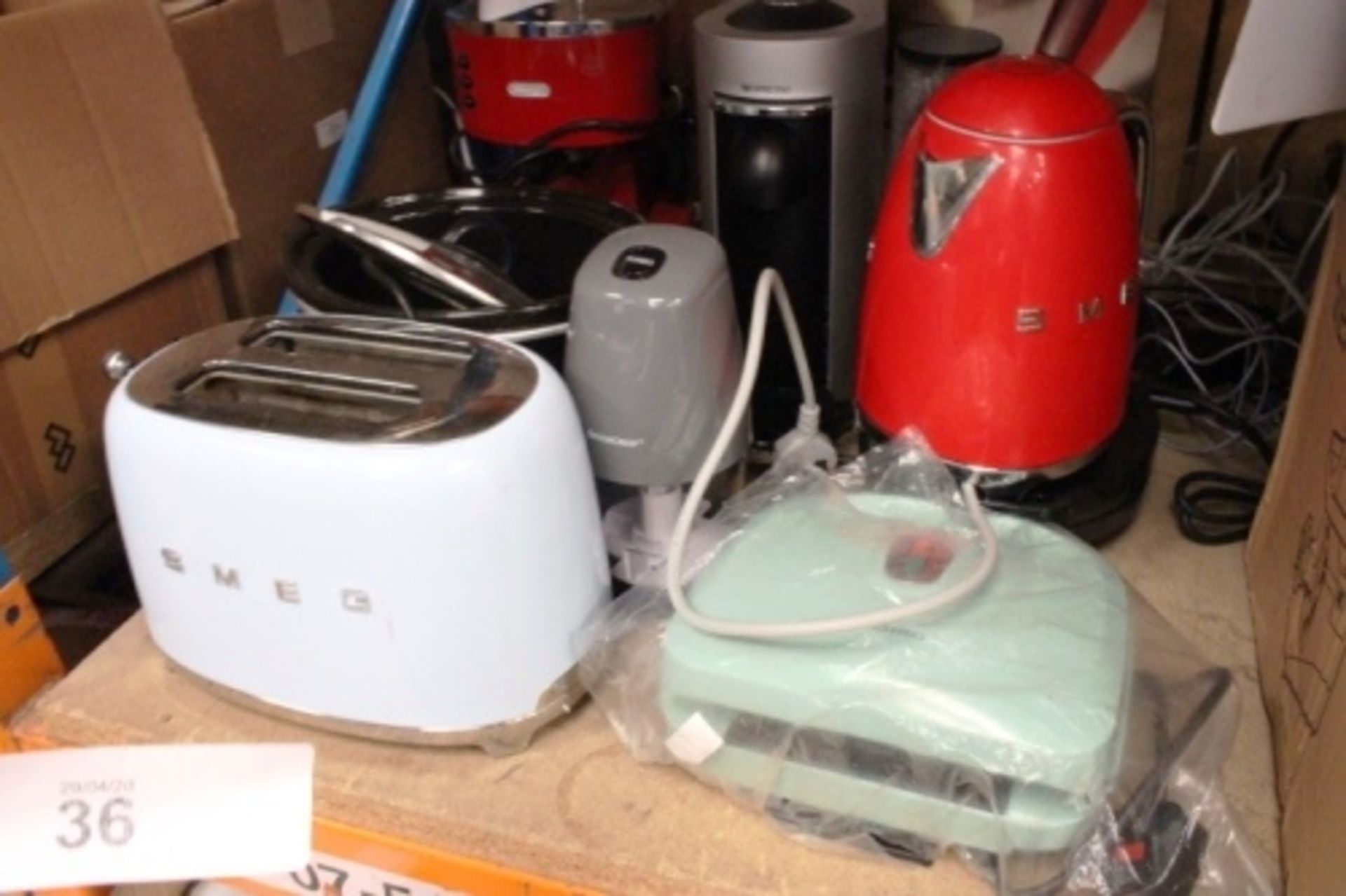 An assortment of kitchen appliances including Delonghi and Magimix coffee machines, Smeg toaster,