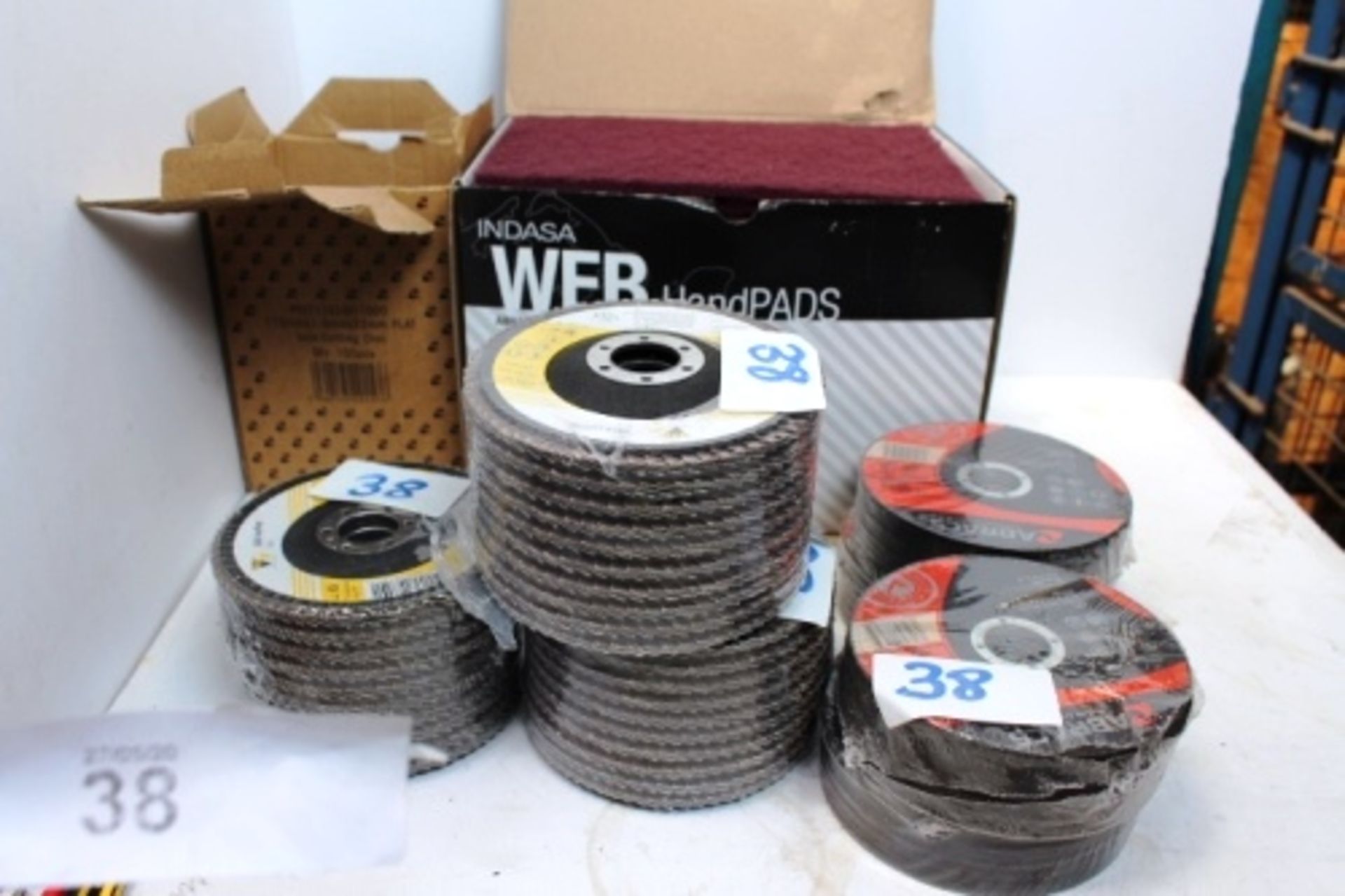 A quantity of grinder cutting and sanding disks together with a box of Indisa abrasive hand pads -