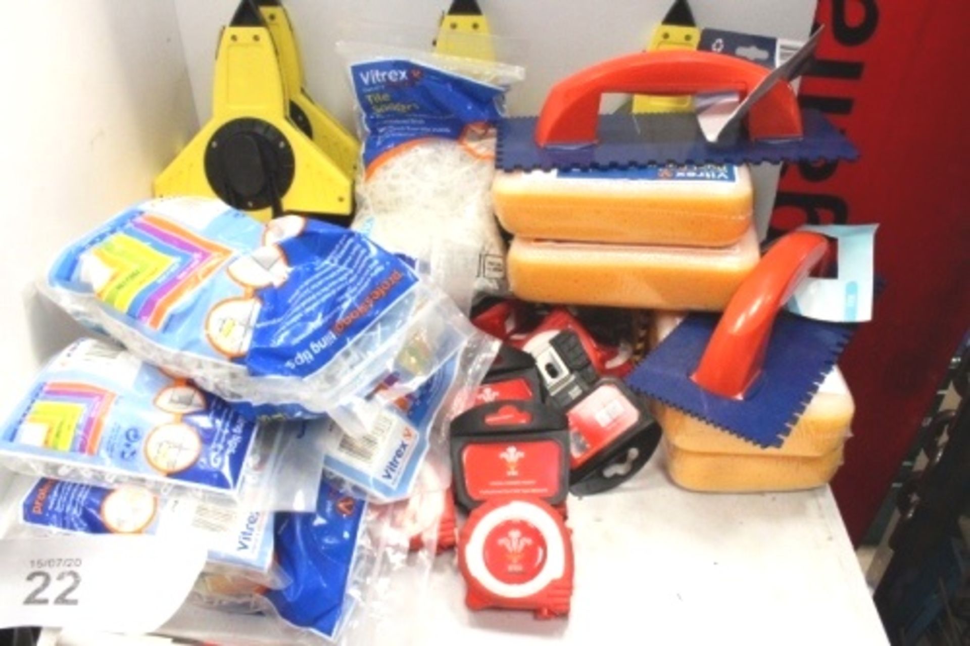 A mixed lot of tools including Welsh Rugby Union tape measures, grouting sponge, grouting pegs,