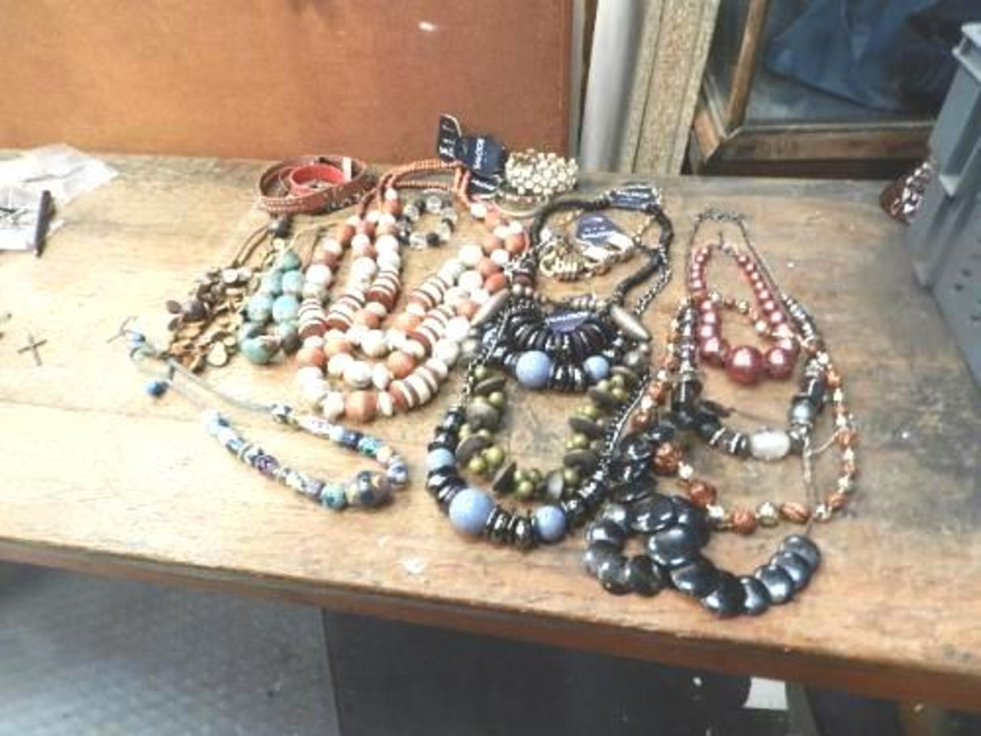 An assortment of costume jewellery consisting of bangles, bracelets, necklaces, men's/ladies/kids