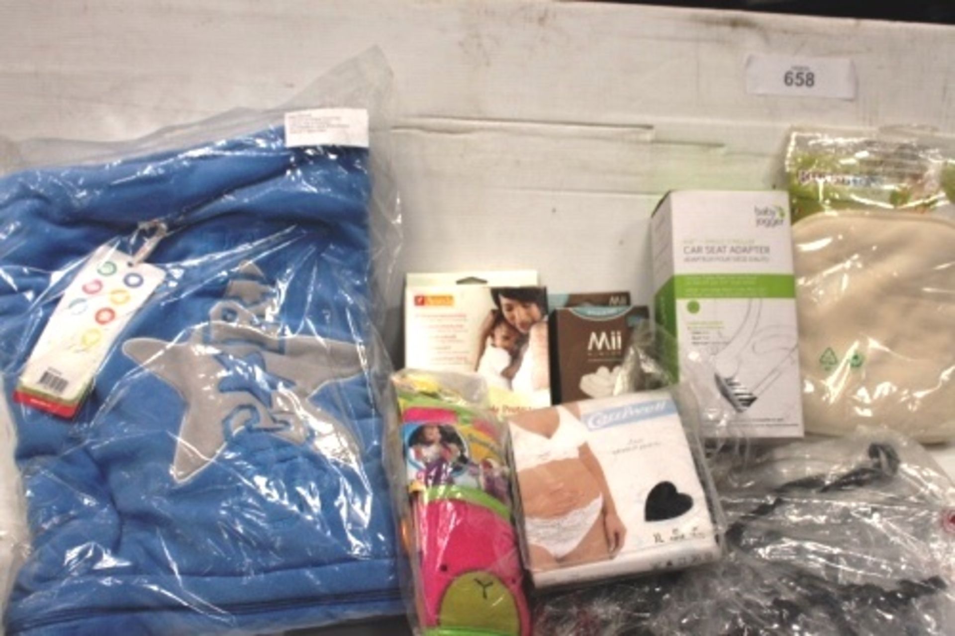 Assorted baby related items including foot muffs, washable nappy liners, nipple shields, pram cover,
