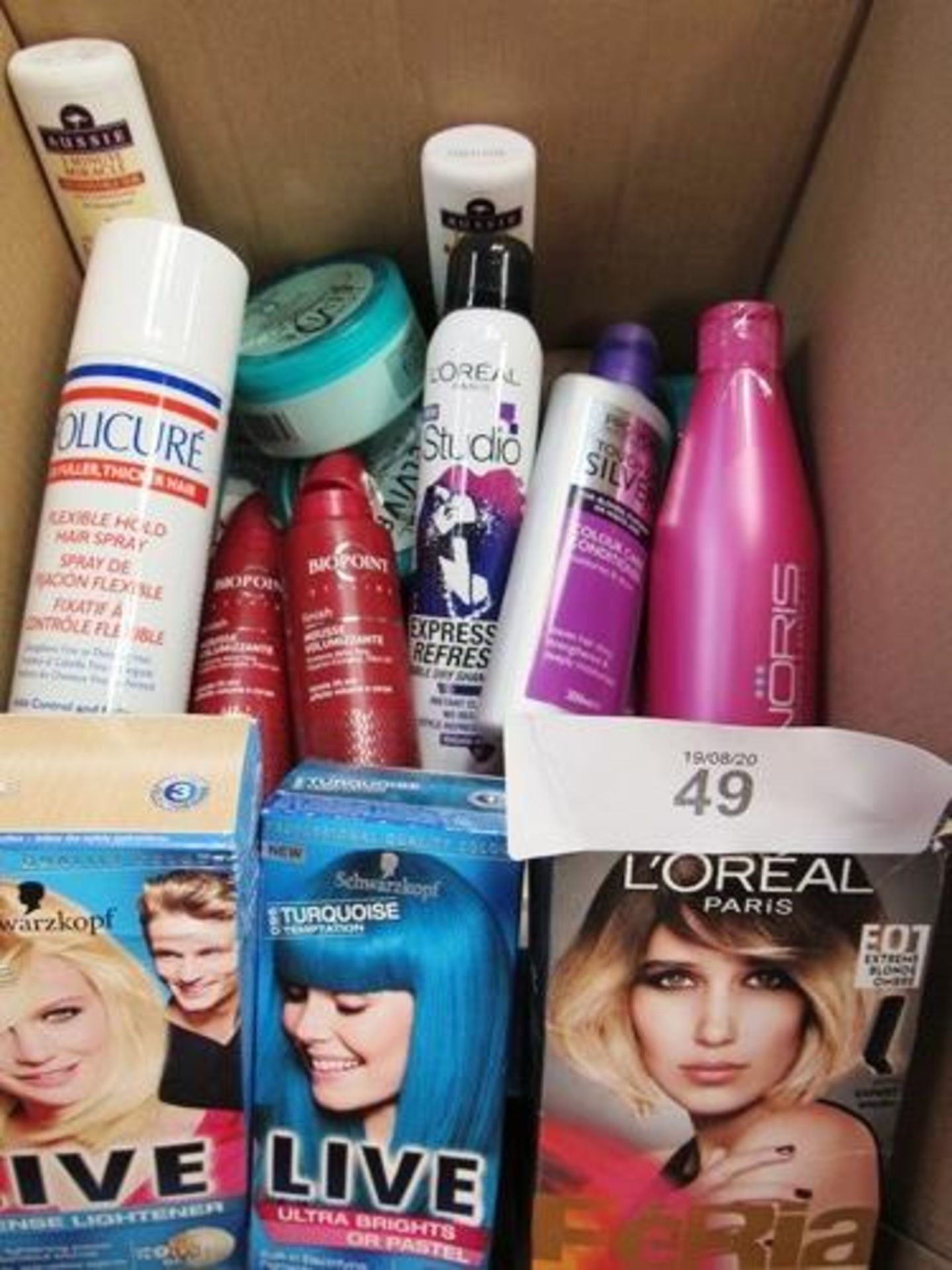 An assortment of hair products including Schwarzkopf Live Dye, Pro Voke conditioner, L'Oreal clay