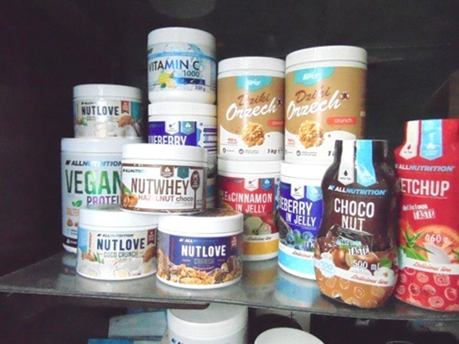 A quantity of food items from All Nutrition and Natural SFD including fruit in jelly, nut spreads