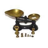 A set of cast iron and brass scales and a graduated set of weights