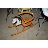 A wooden rocking horse chair