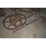A pair of cast iron wheels and an axle