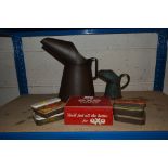 Two oil pouring cans and a quantity of old adverti