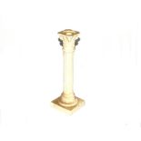 A white glazed china Corinthian column candlestick