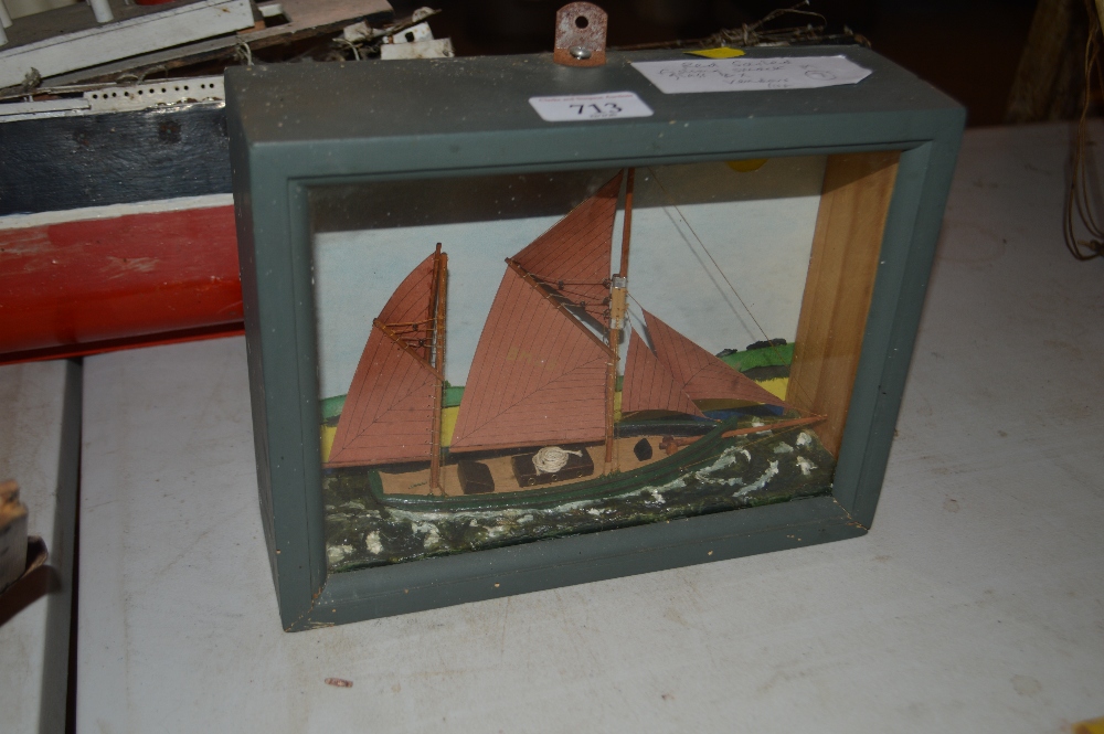 A small model of a red sailed fishing smack, in glazed c