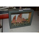 A small model of a red sailed fishing smack, in glazed c