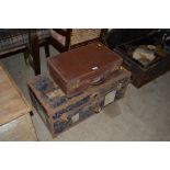 A metal bound trunk and a leather covered suitcase