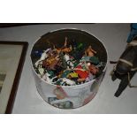 A tin of various vintage plastic figures and toys