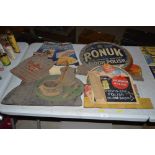 A collection of vintage cardboard advertising sign