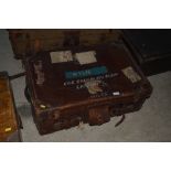 A leather trunk with various old part luggage labe