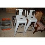 A pair of industrial style high stools