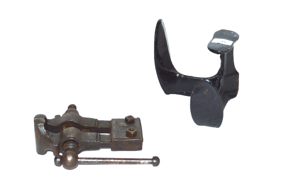 A vintage iron vice and a cast iron shoe